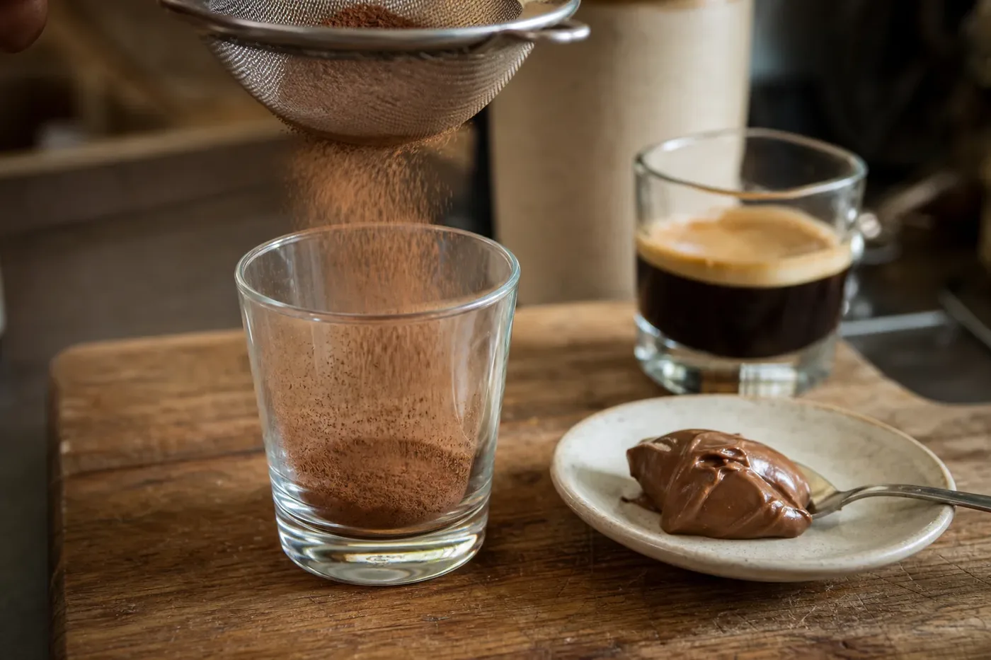 Cocoa dusted into a small glass before making a marocchino