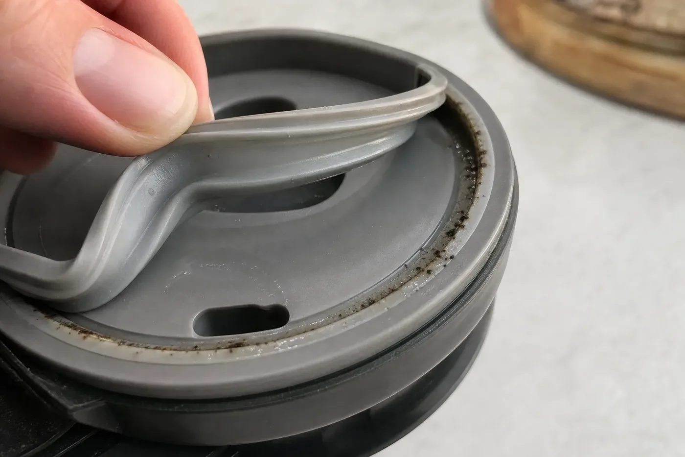 Dark specks of mould hidden in the groove under a travel mug lid seal