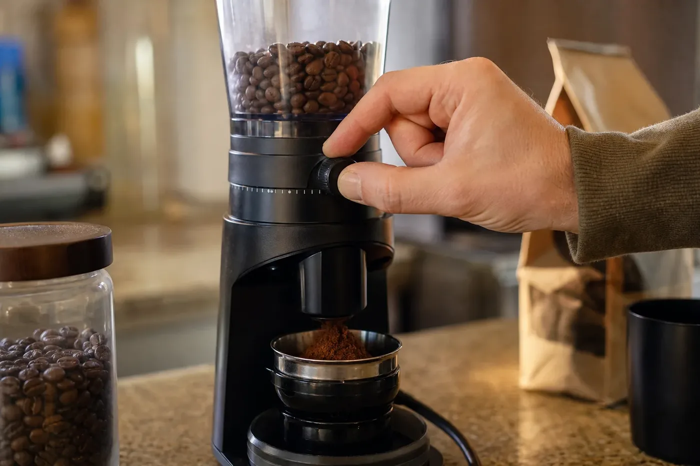 Adjusting a burr grinder finer to fix a sour espresso shot
