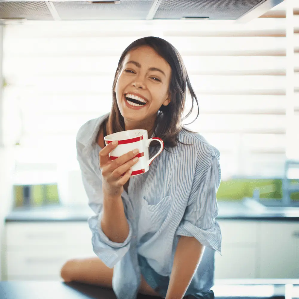 woman energized from caffeine and enjoying her cup of coffee