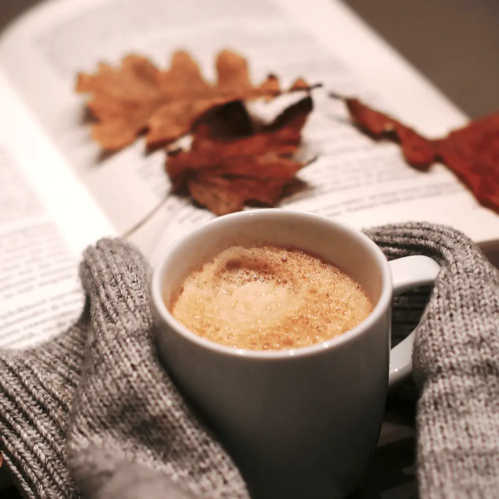 cup of coffee with autumn leaves
