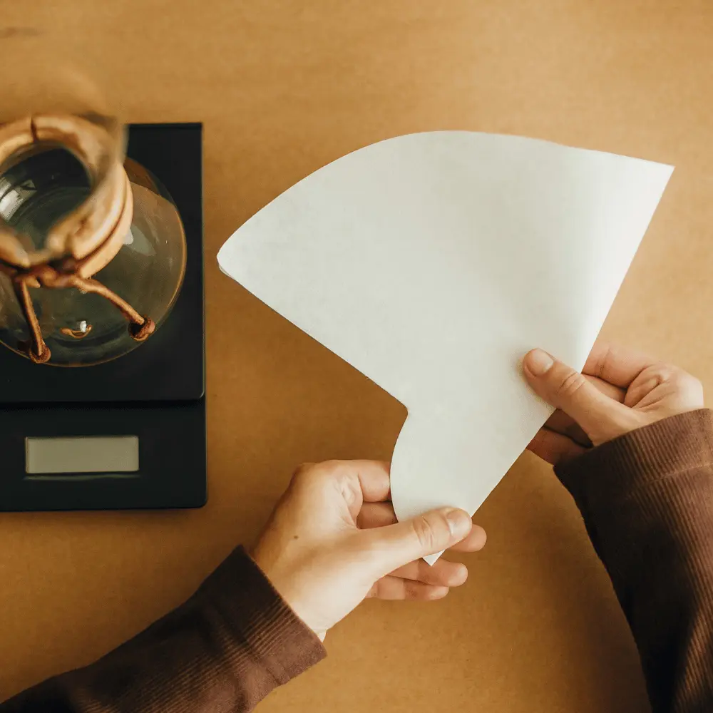 woman preparing a paper coffee filter