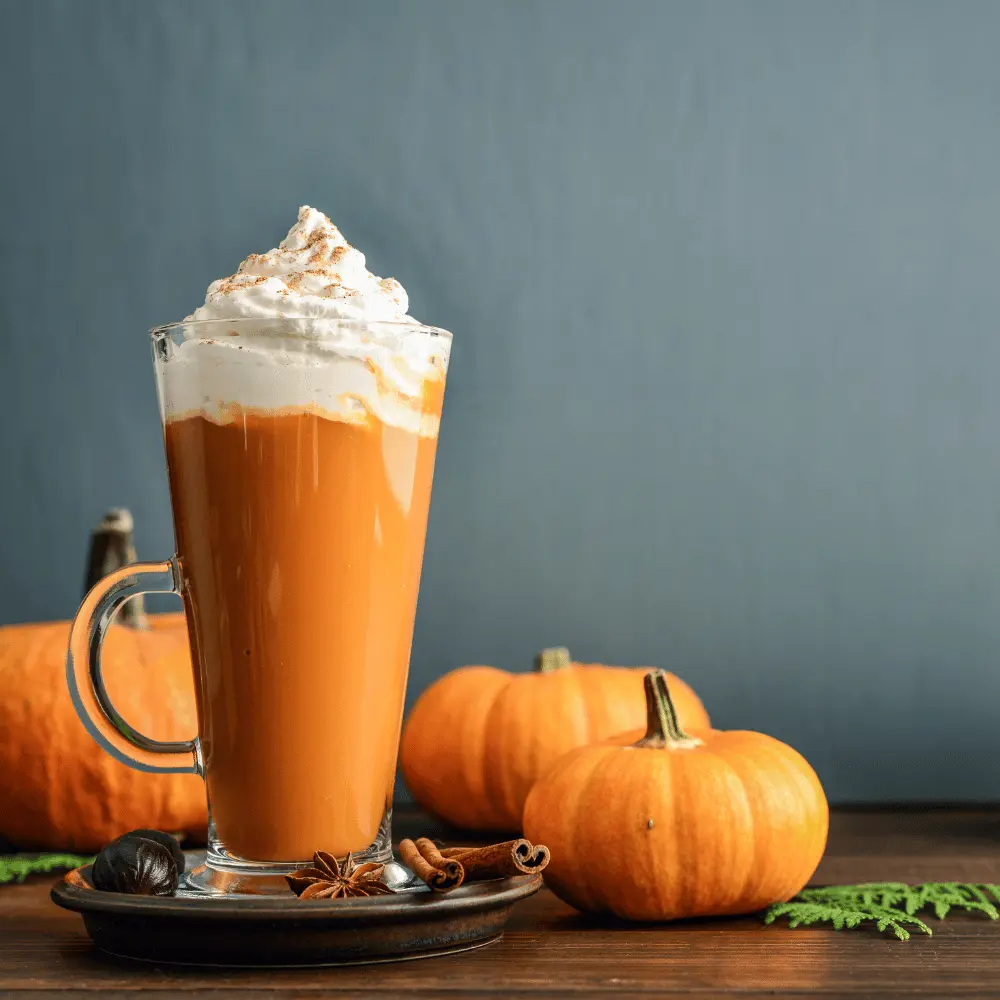 a glass of delicious autumn drink pumpkin spice latte on a table.
