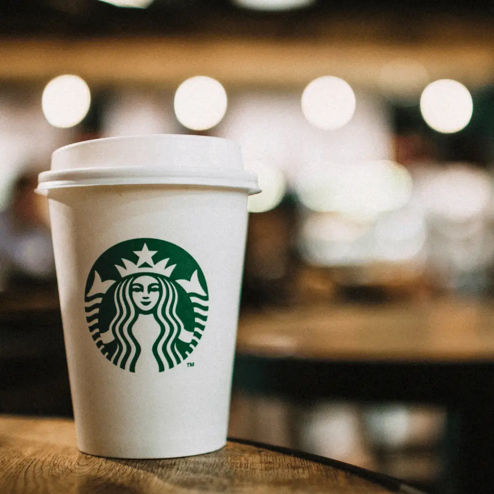 a small-sized cup of starbucks coffee on a table