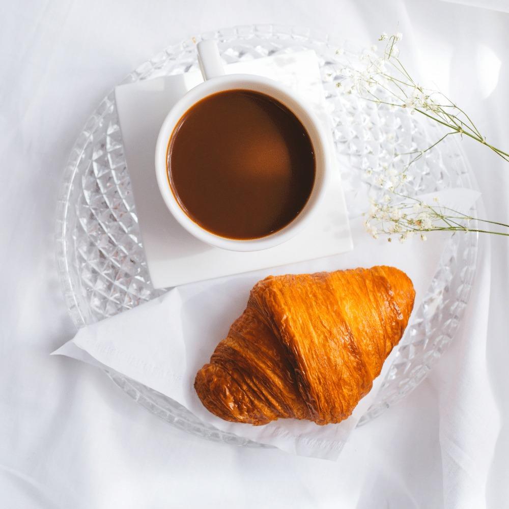 coffee served with a fresh croissant