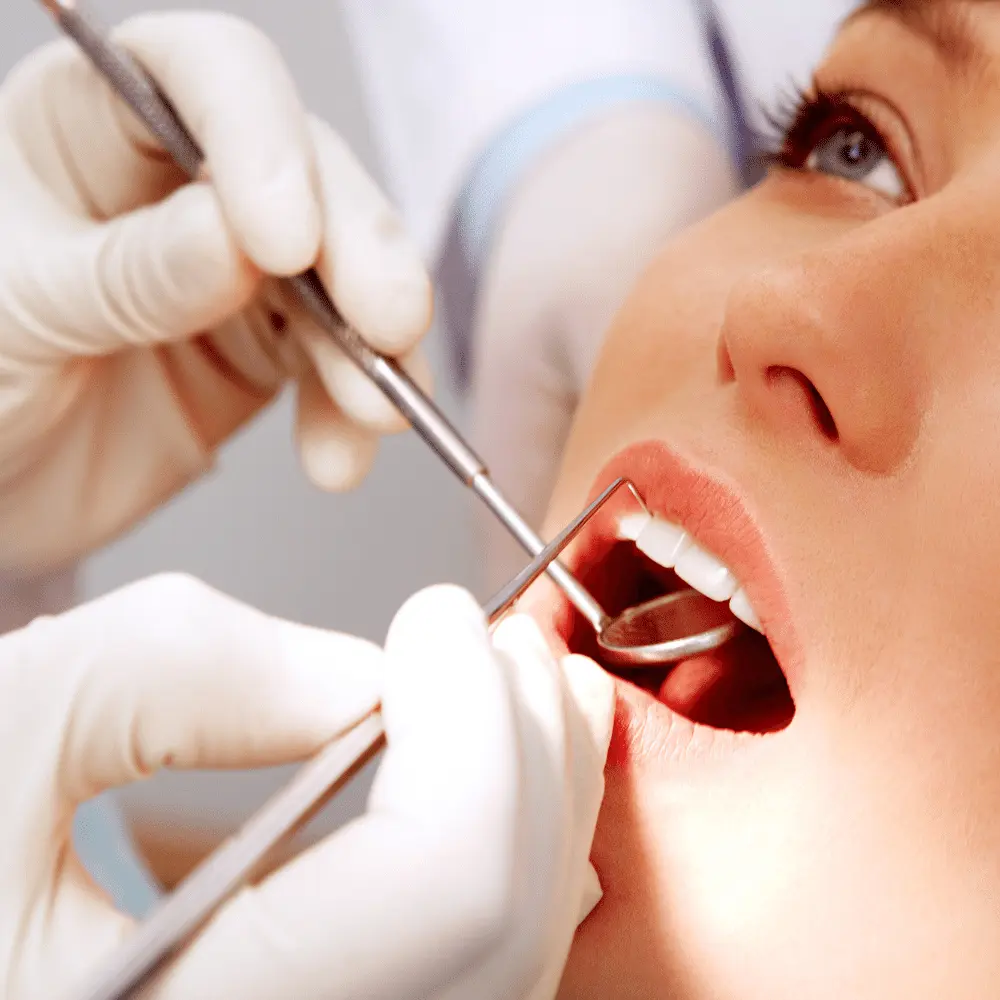 lady getting her teeth checked at dentist