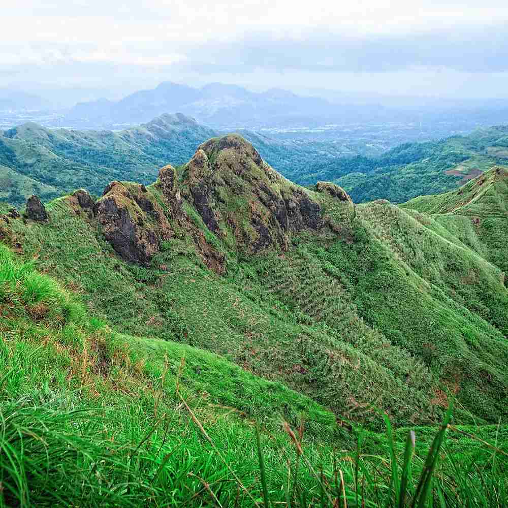 a lush green valley with mountains in the philippines