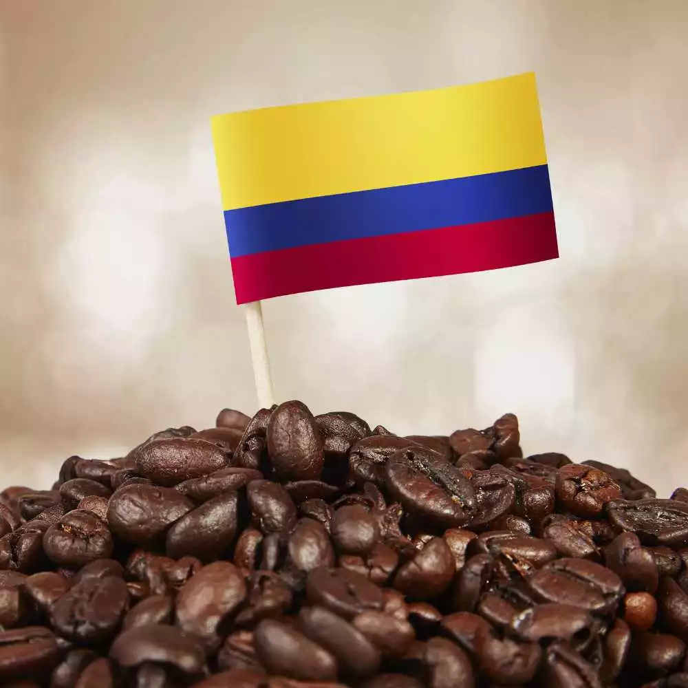 Colombian coffee flag in a stack of coffee beans