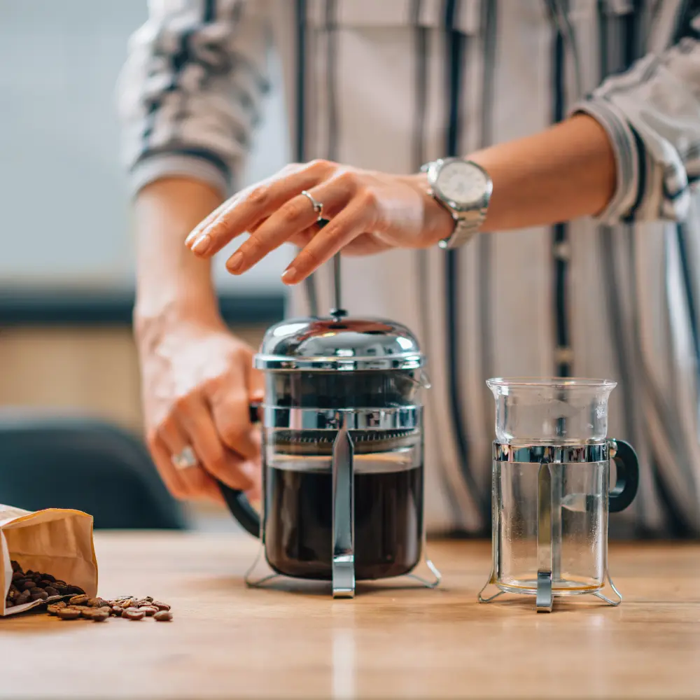 woman brewing coffee using a french press