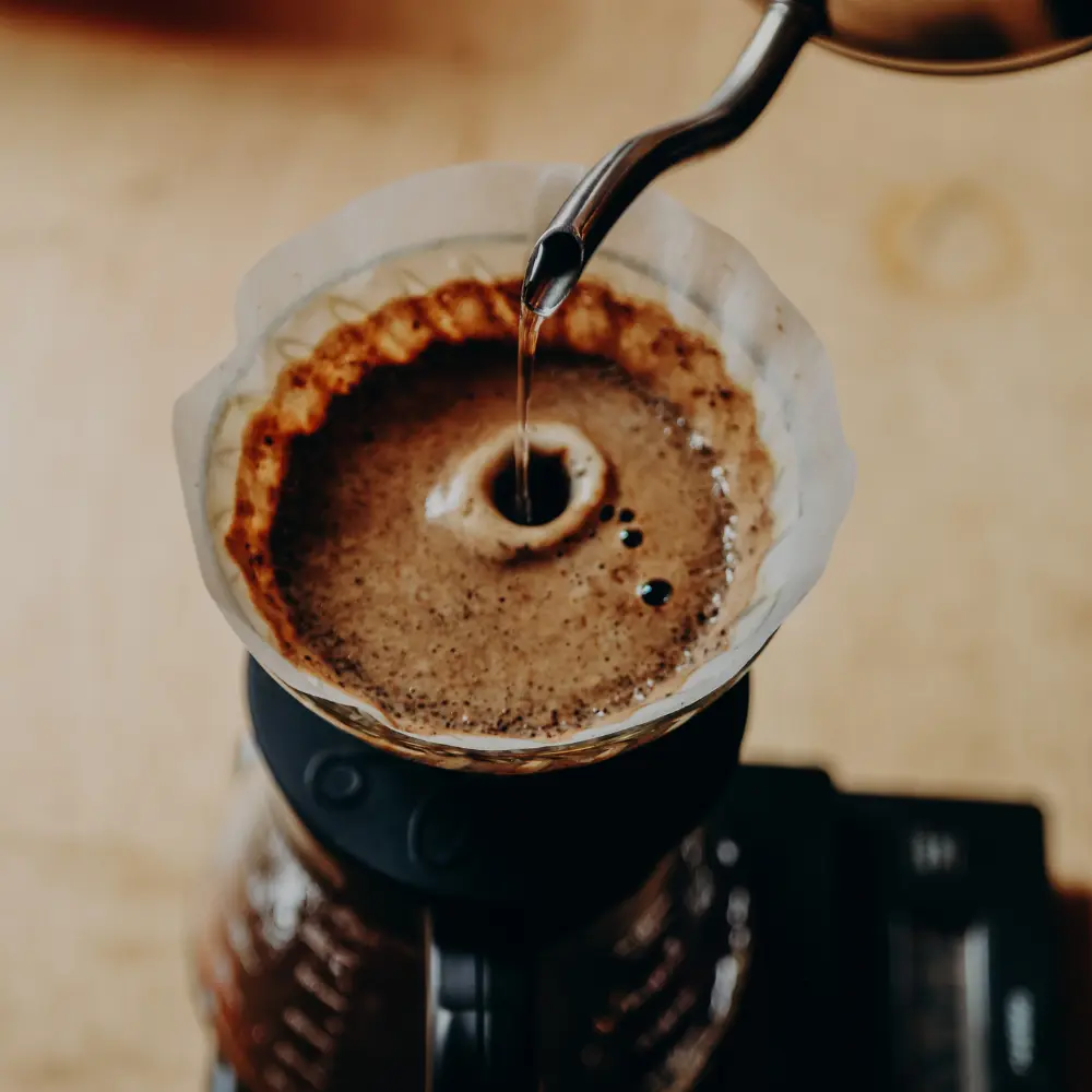 pour over coffee being brewed with gooseneck kettle