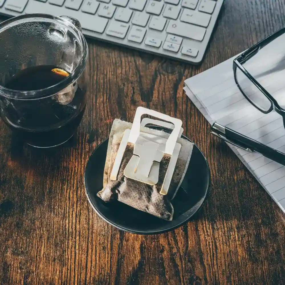 pour over on saucer and desk near laptop