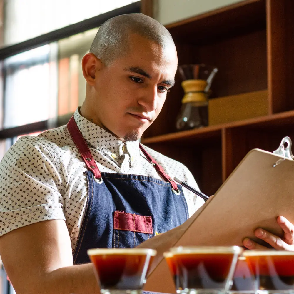 man grading coffee during a coffee cupping session