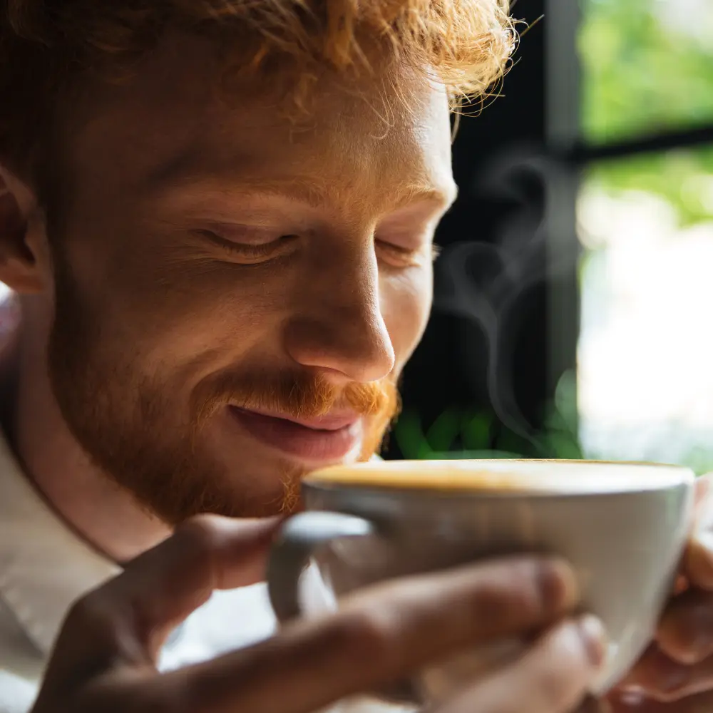 man smelling the amazing aroma of black ivory coffee