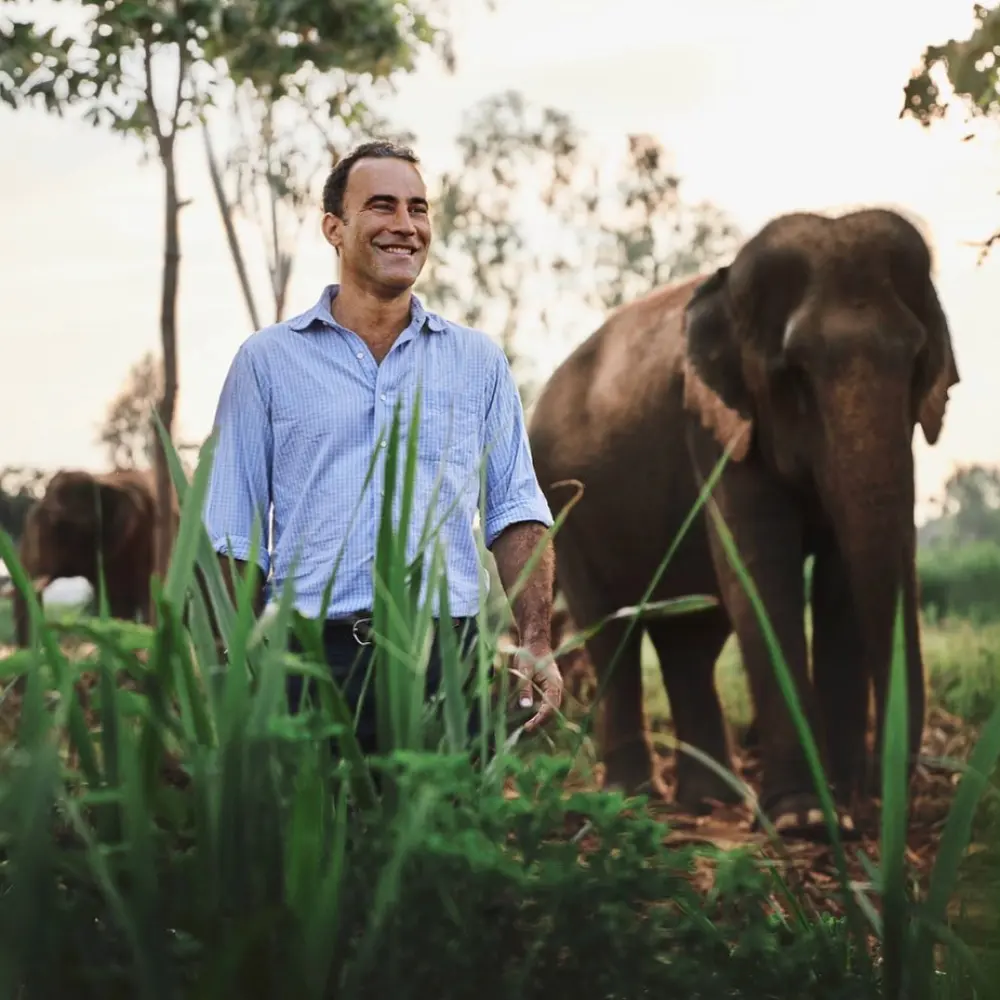 blake dinkin walking with an elephant