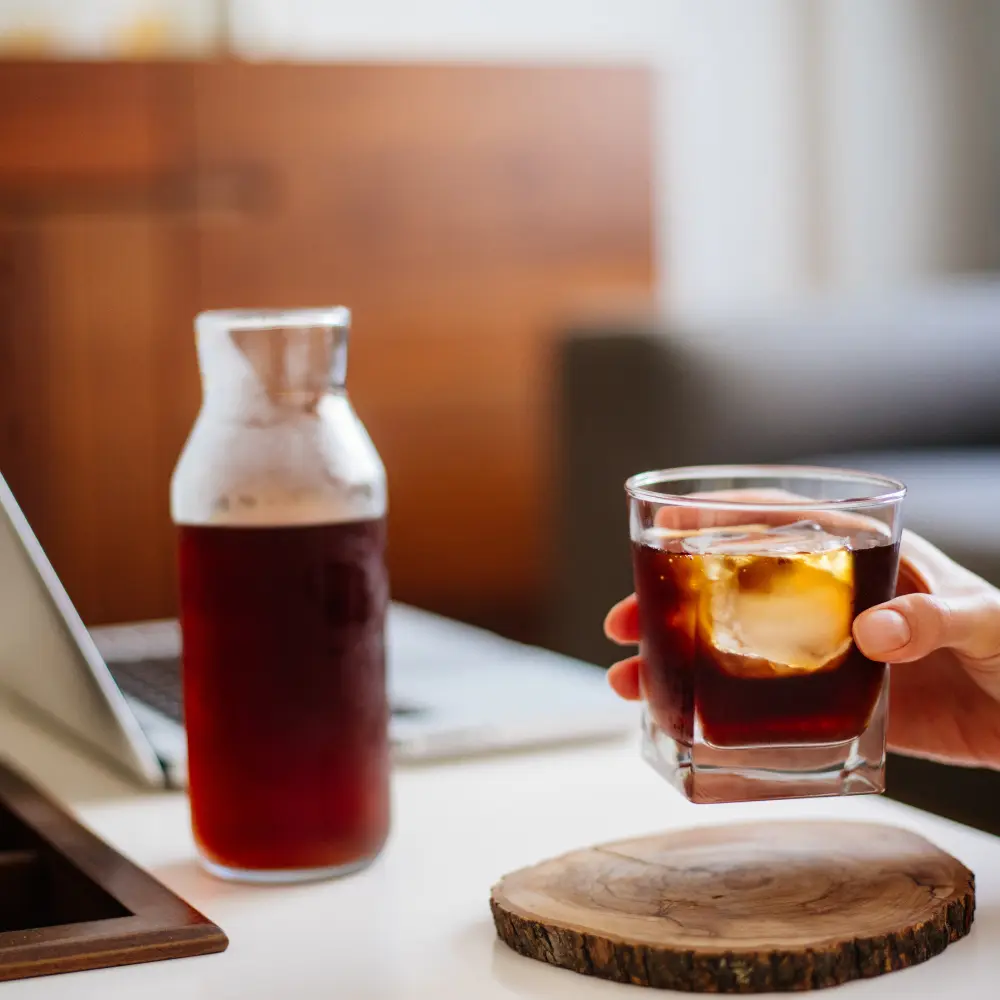 person holding a glass of cold brew coffee