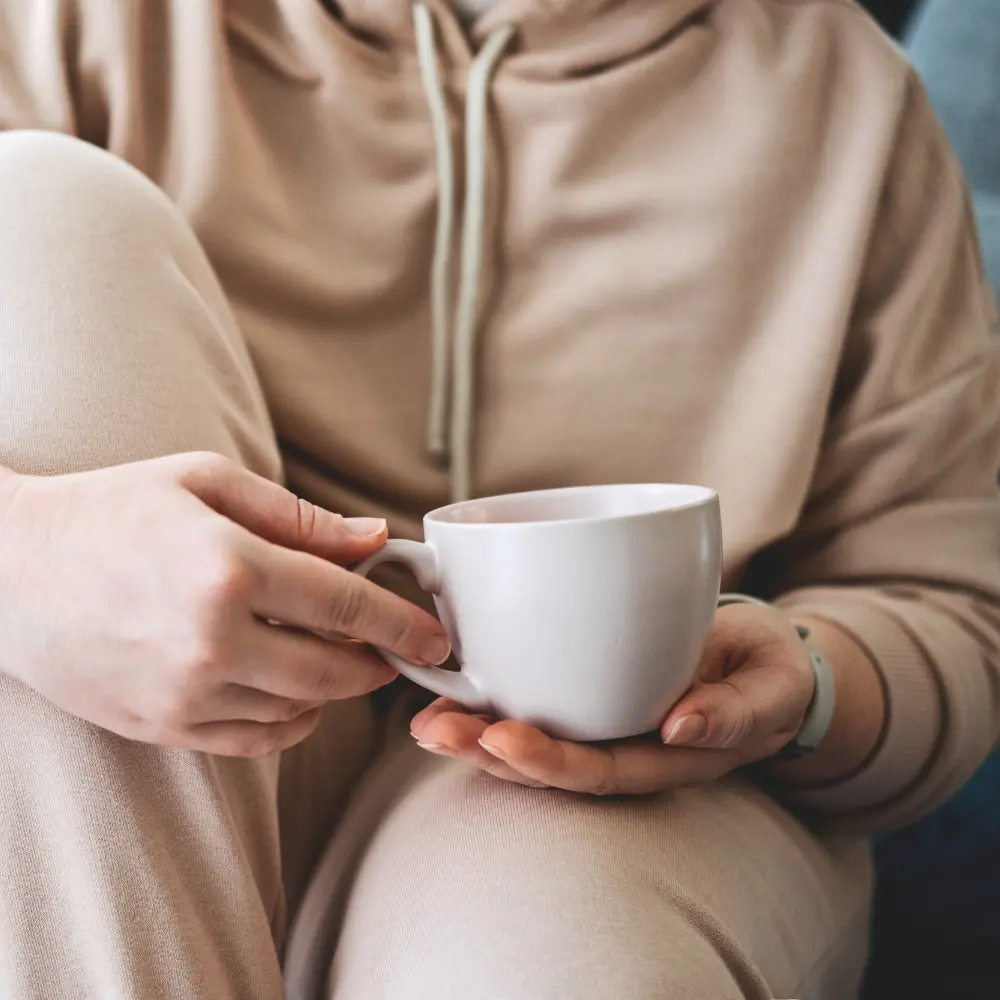 person holding a mug