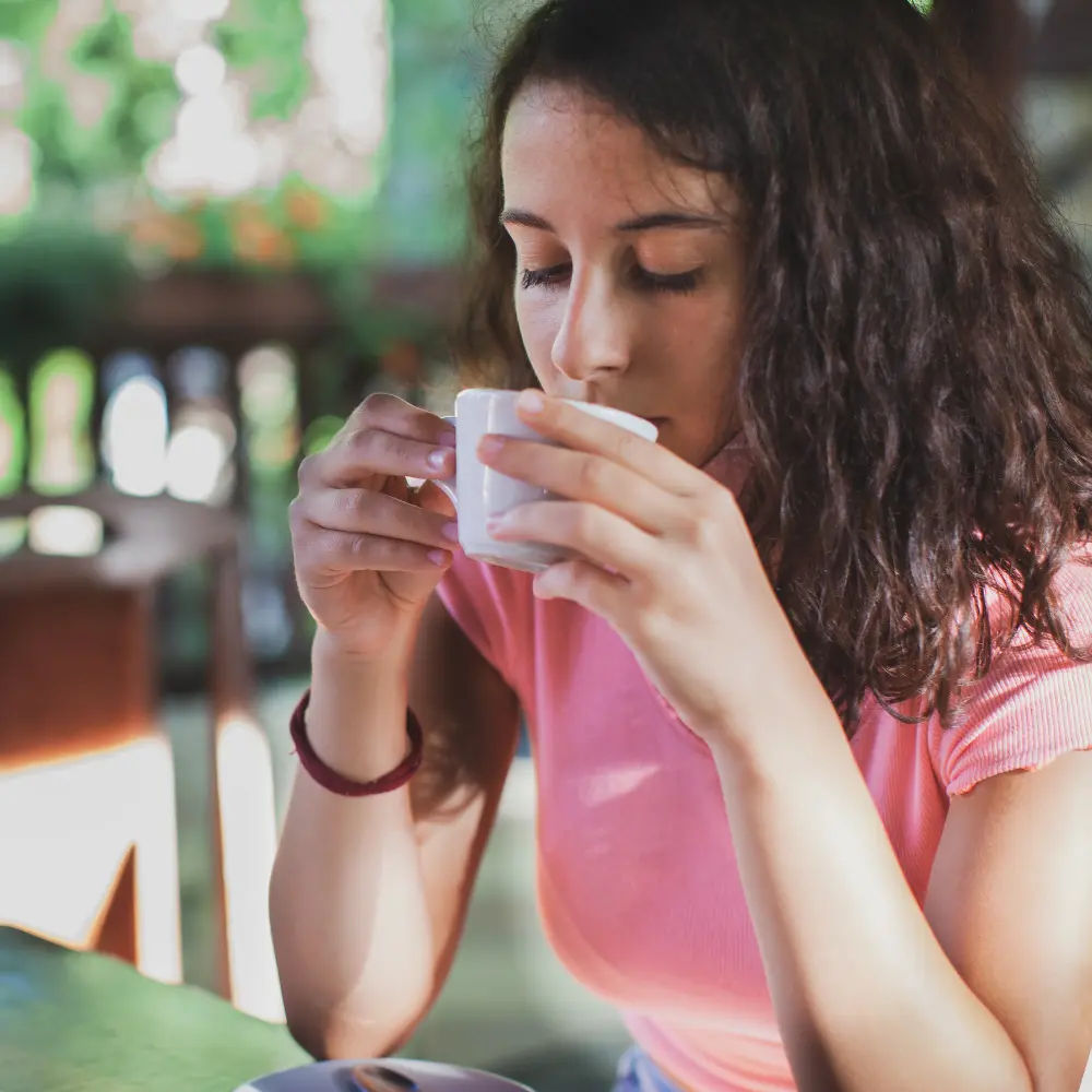 woman tasting her coffee