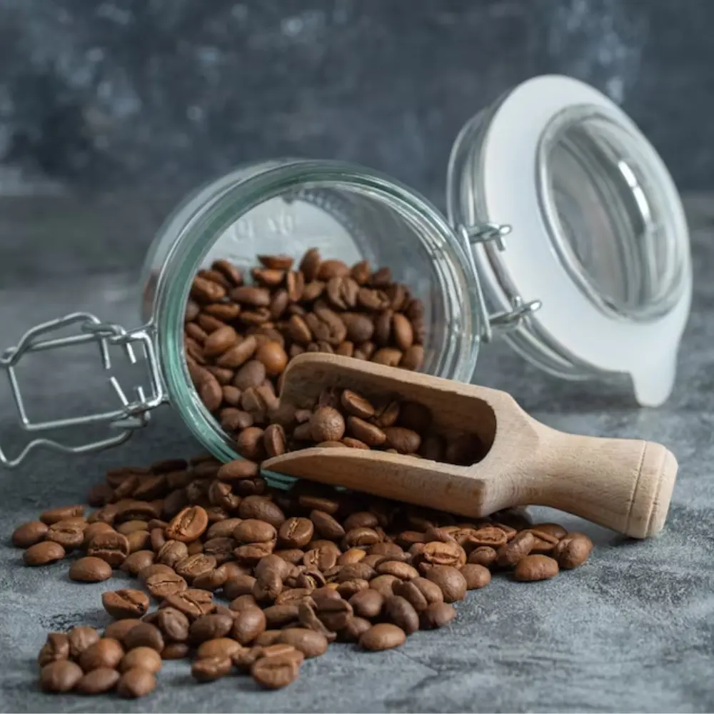 beans pouring out of a mason jar with a scoop