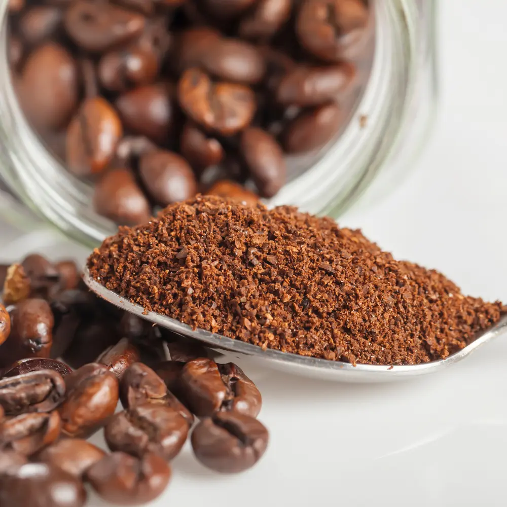 a spoon of ground coffee beans