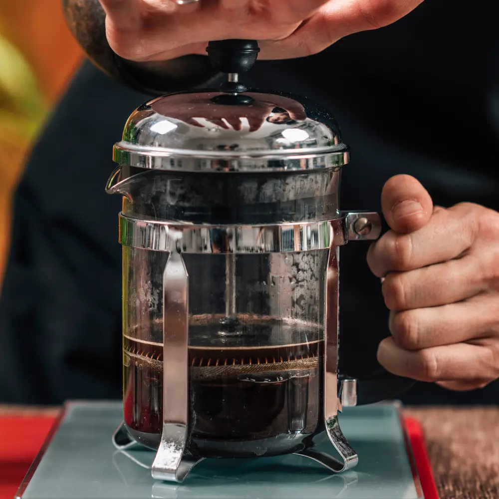 french press coffee maker being pressed