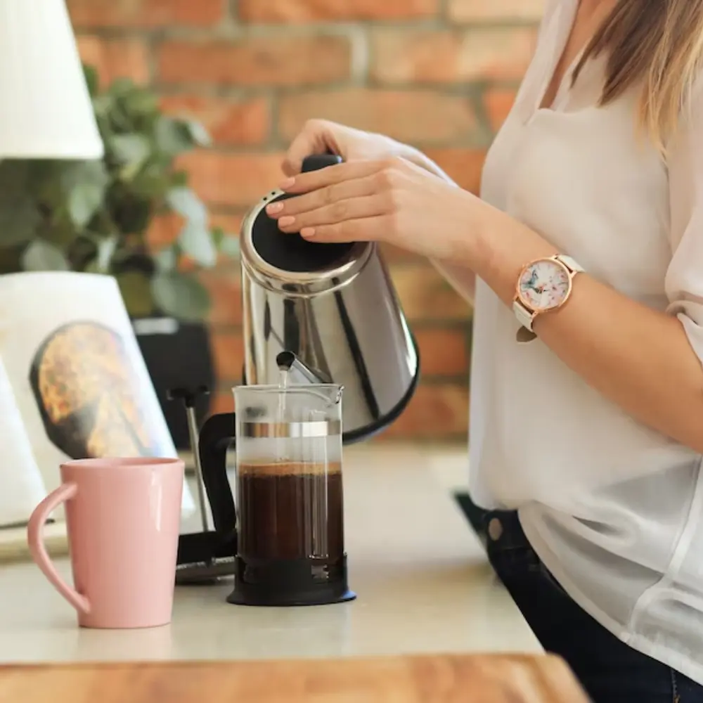 woman brewing french press coffee
