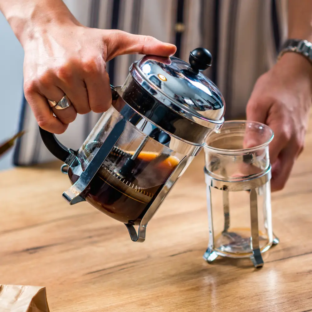man pouring a french press