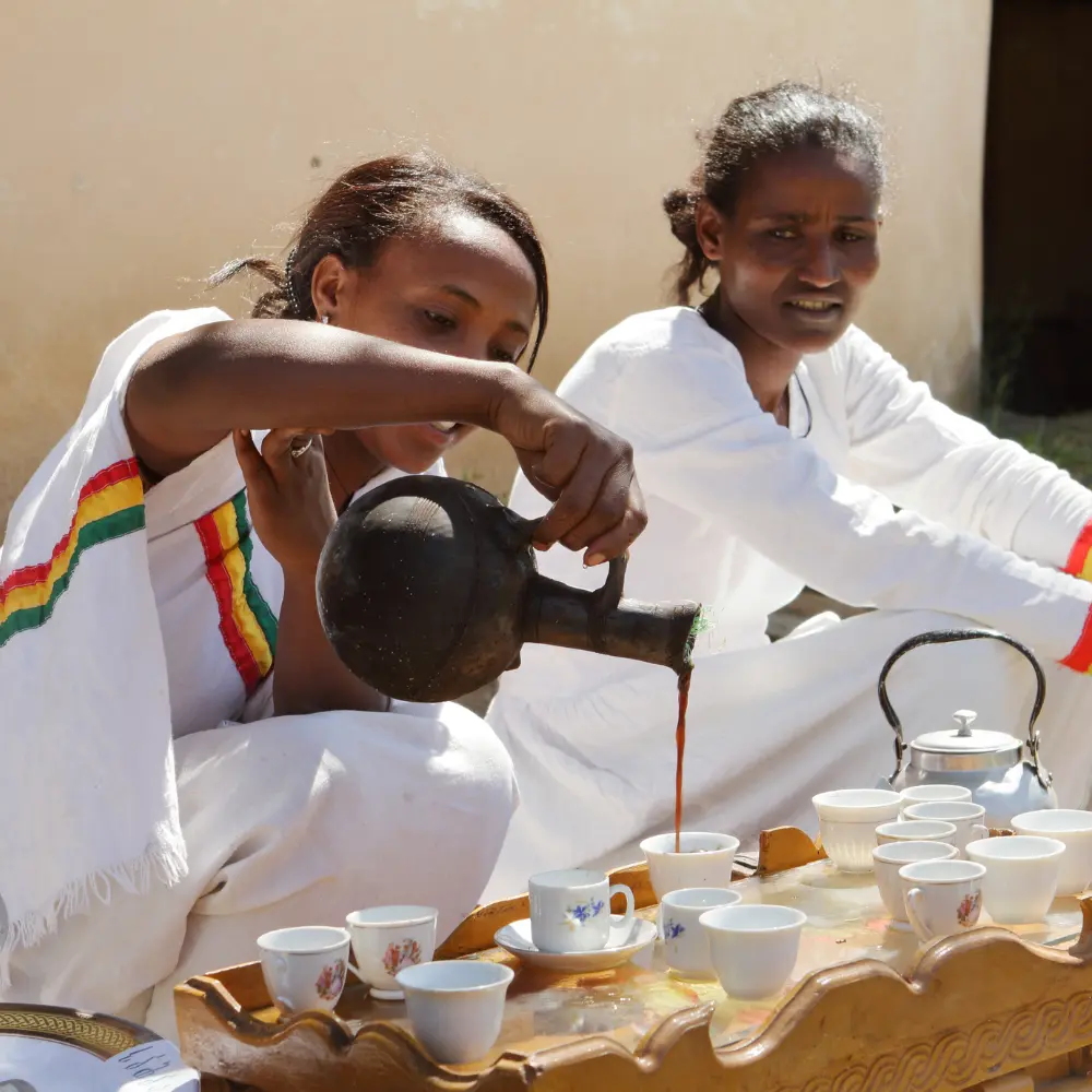 women pouring coffee during an Ethiopian coffee ceremony