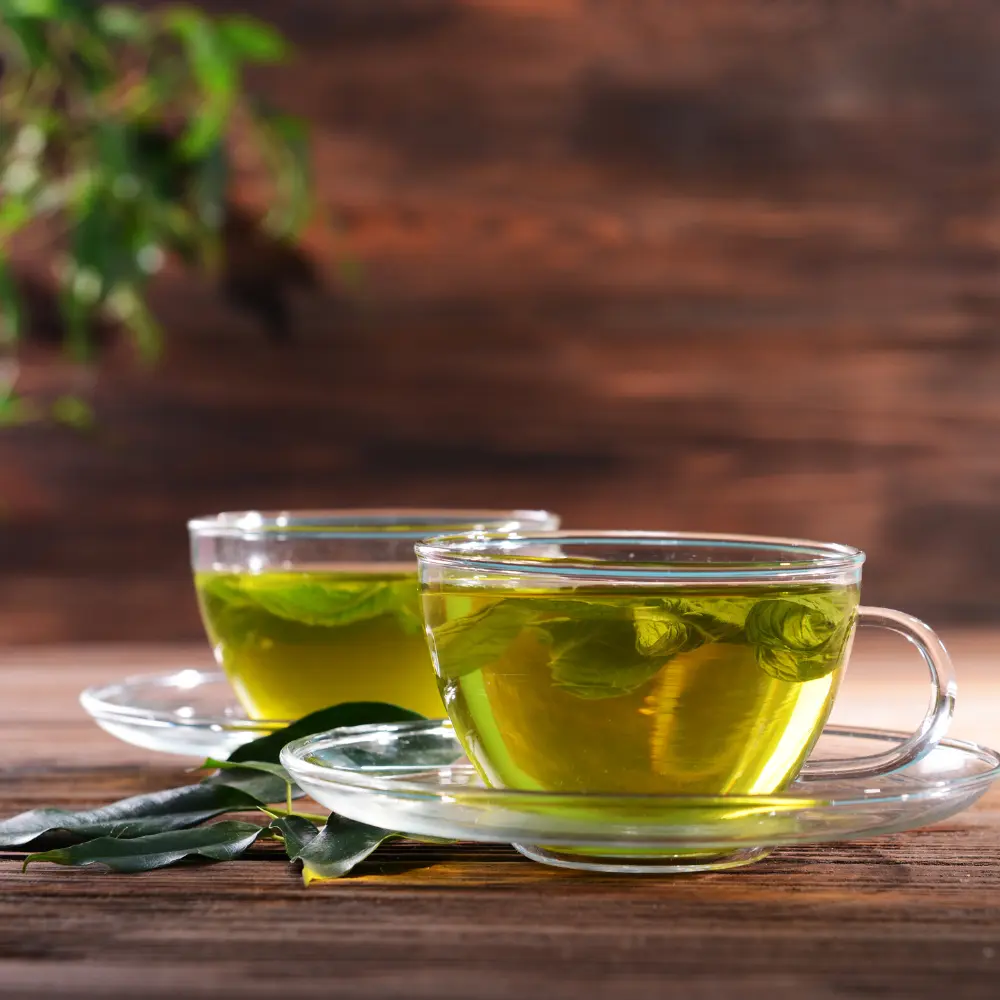 two clear mugs of green tea