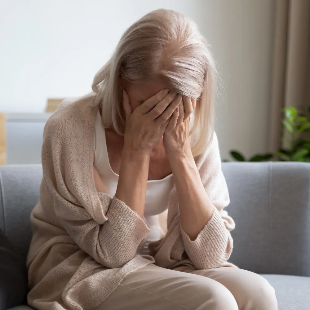 woman feeling unwell holding her head
