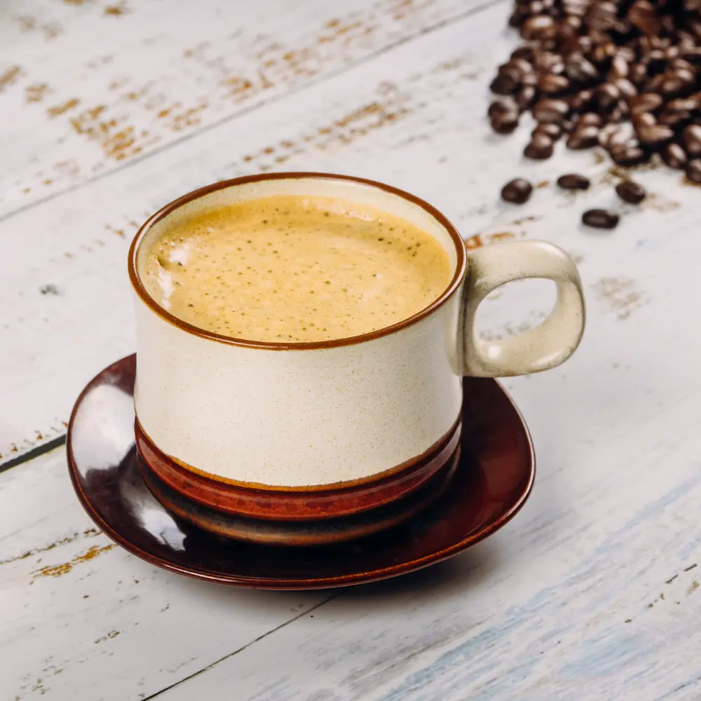 a creamy coffee in a traditional polish coffee mug