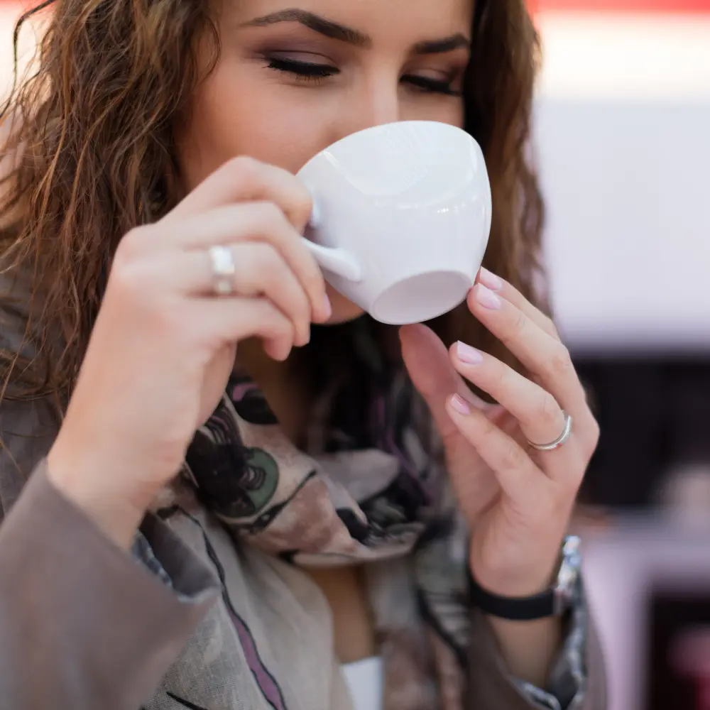 woman drinking a caffe crema