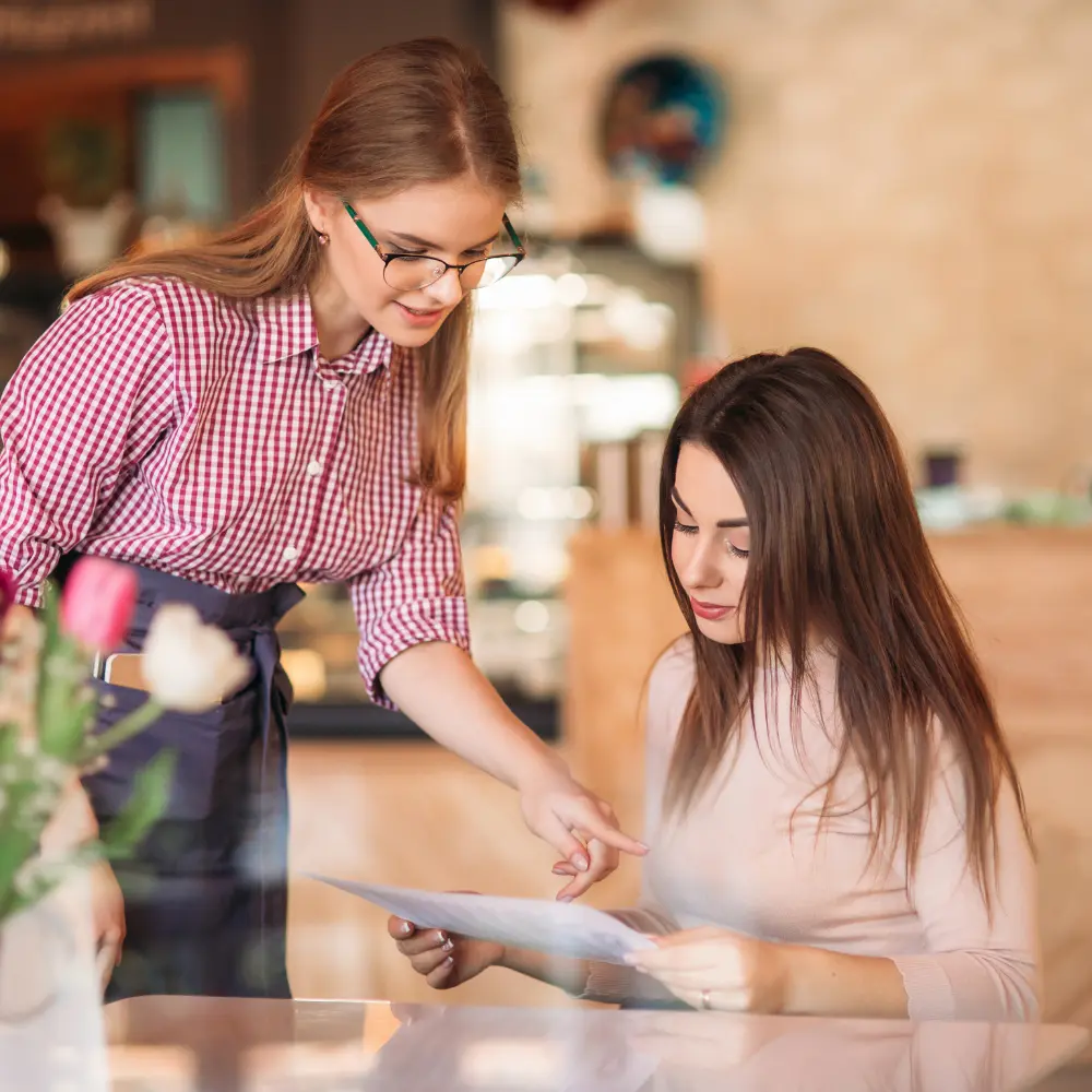 woman ordering from a waiter while waiting for her date