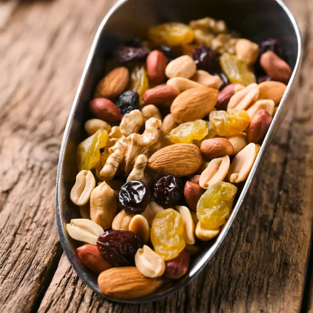 a scoop with various nuts and raisins