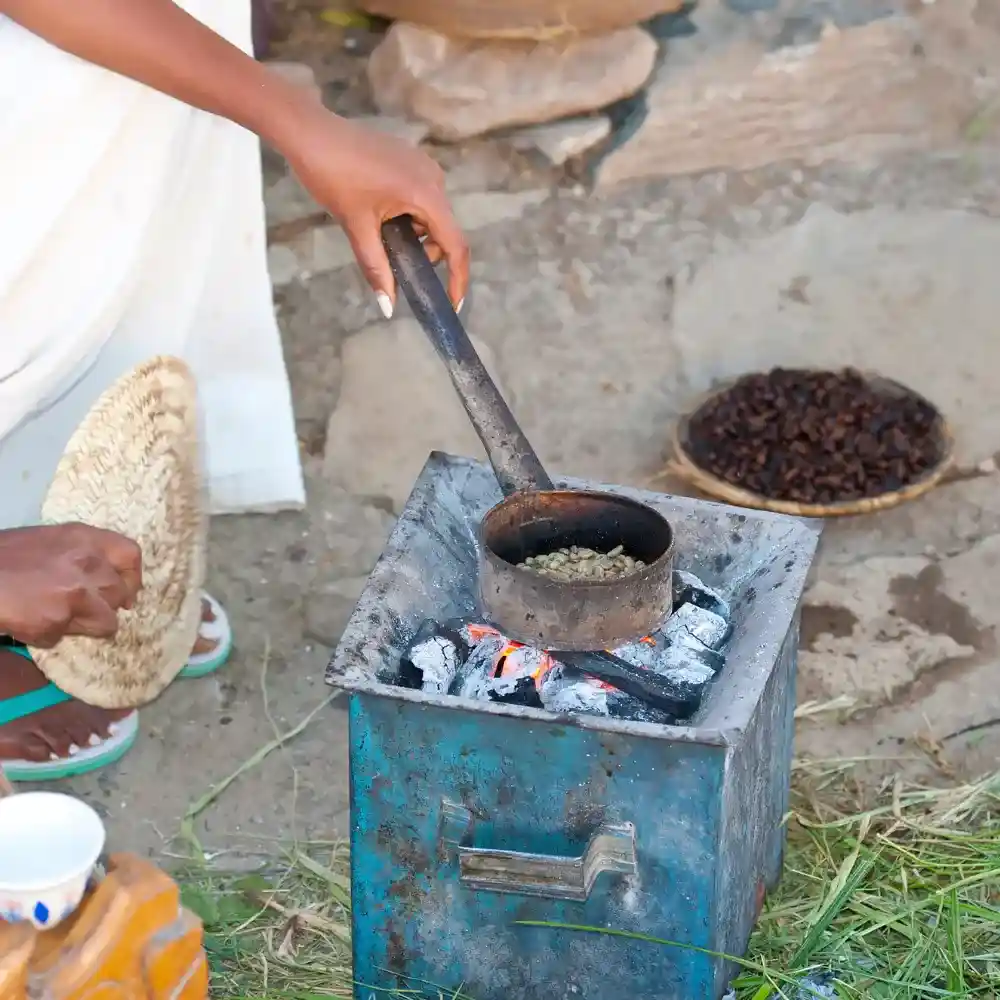 woman roasting coffee beans using a menkeshkesh