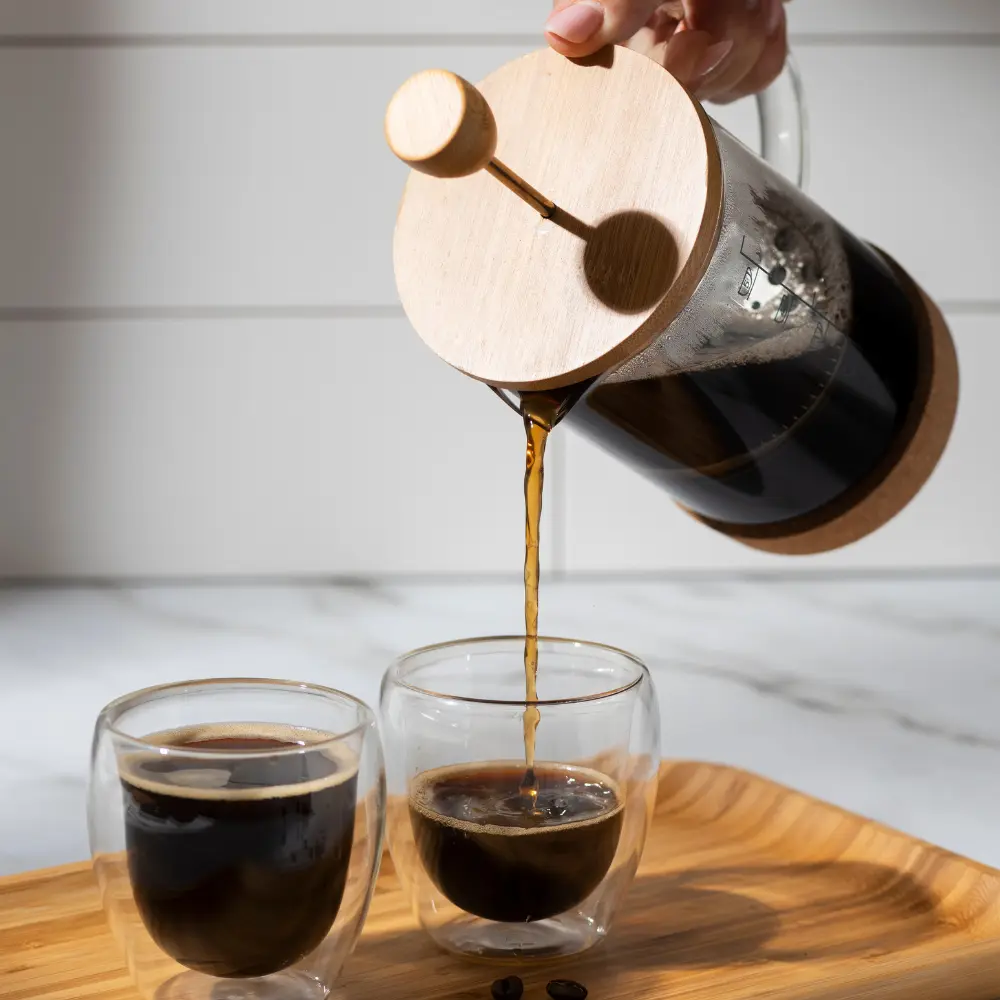 french press coffee maker pouring freshly brewed coffee
