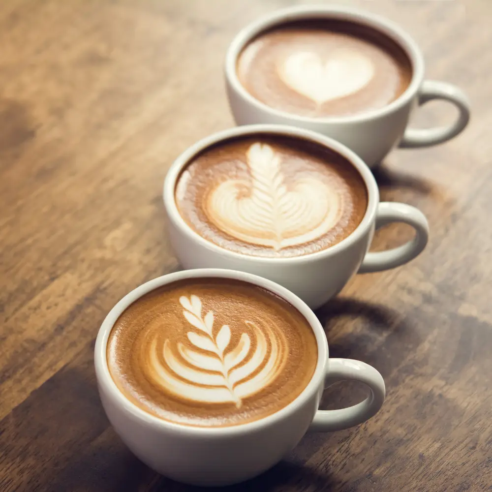 three mugs of milk coffees
