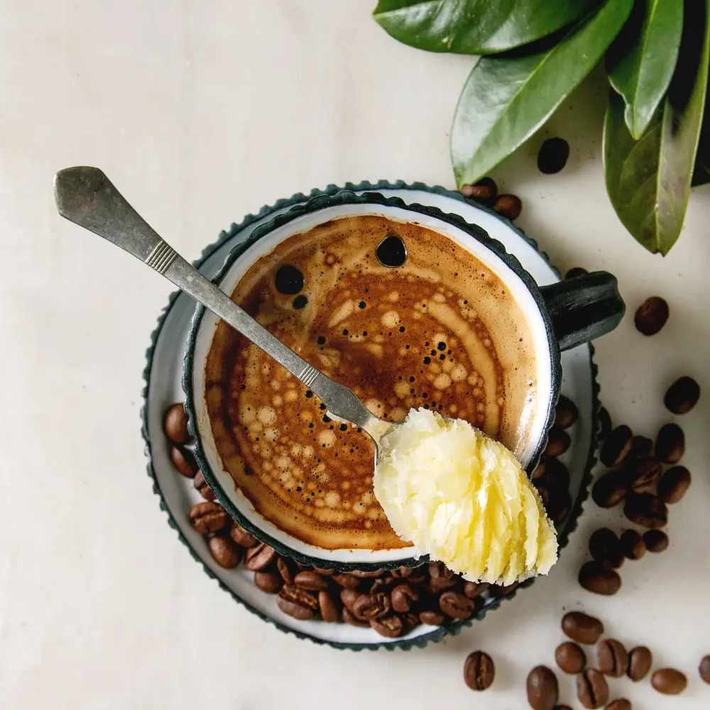 black coffee with a spoon of butter