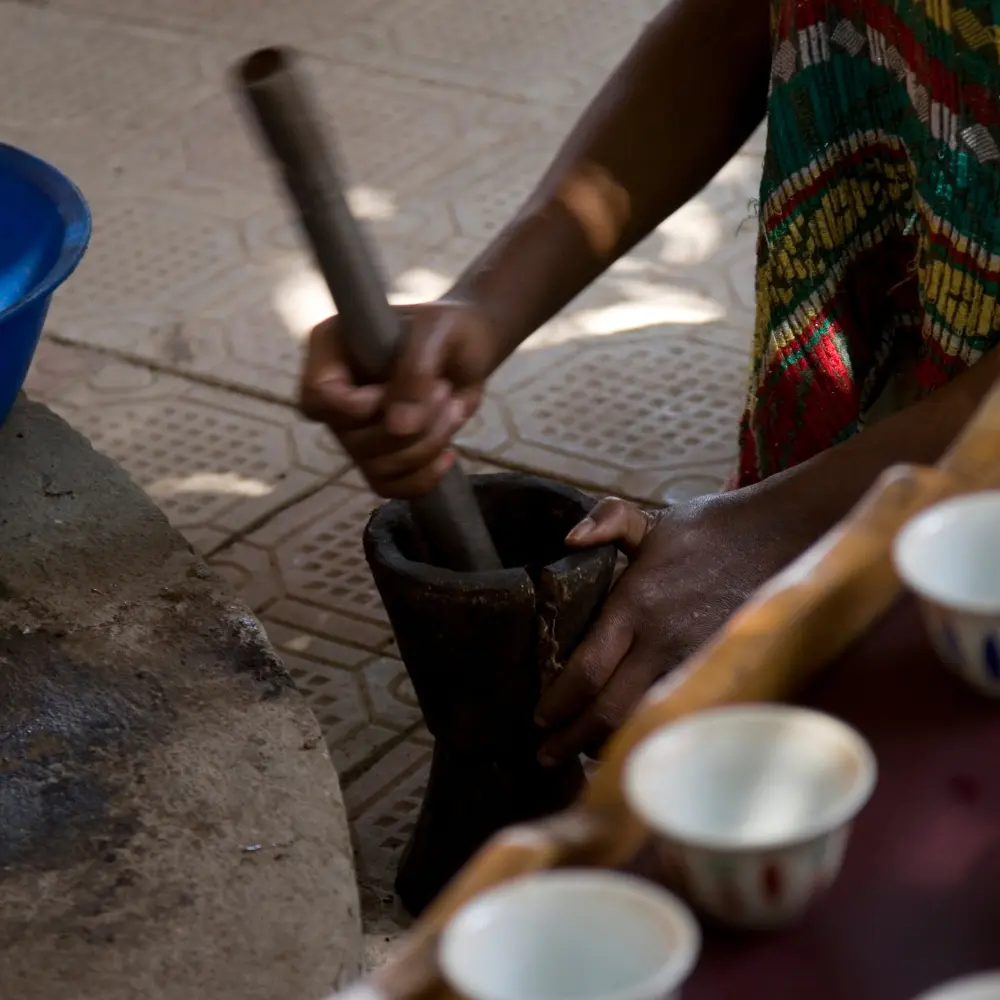 person grinding beans by hand