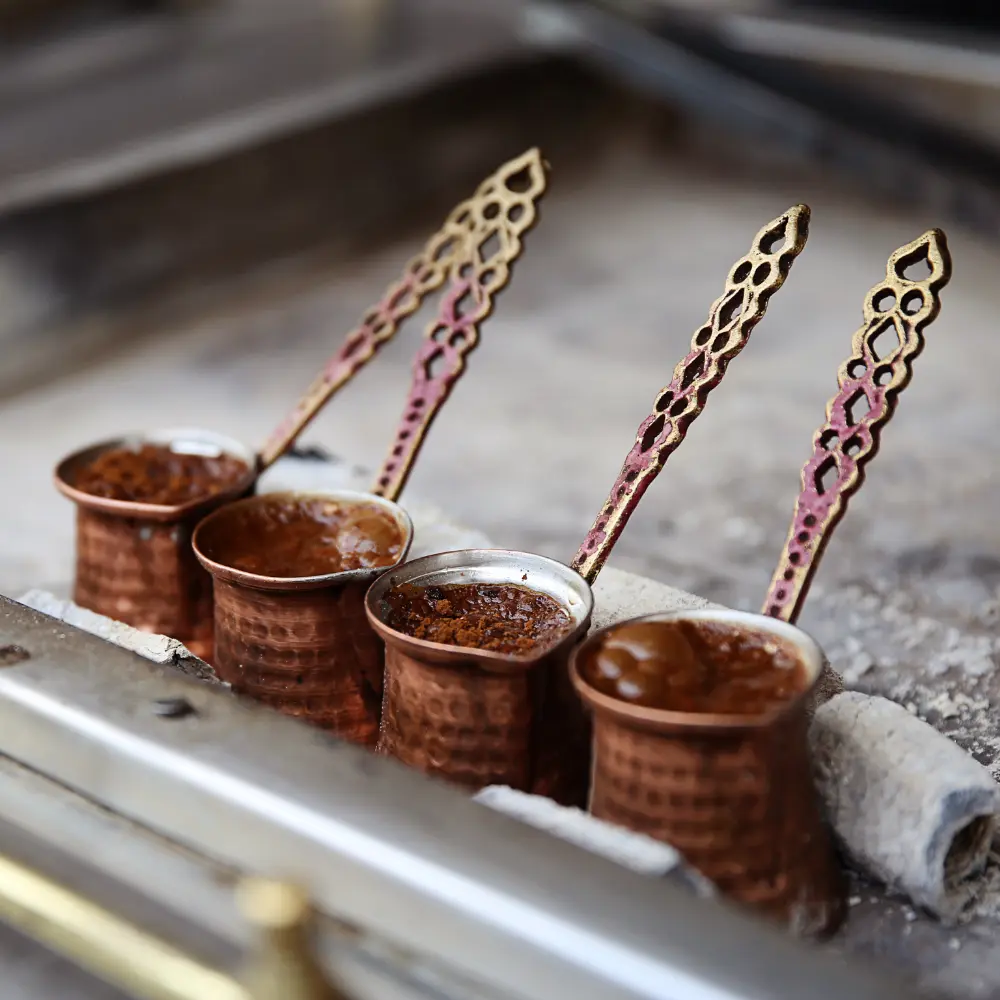 traditional turkish coffee pots brewing coffee in sand