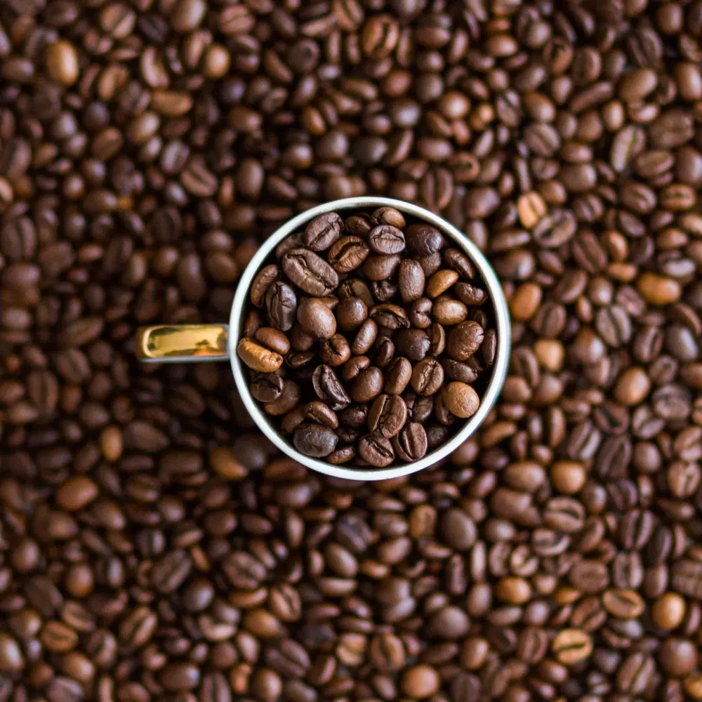 a coffee mug filled with coffee beans