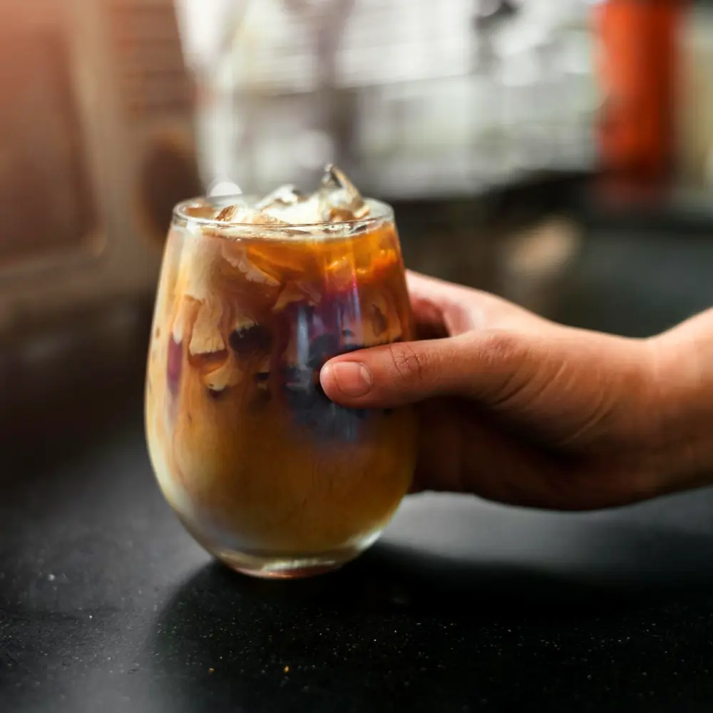 hand holding a dunkin sunrise batch iced coffee