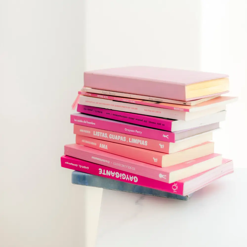 a stack of pink coffee table books