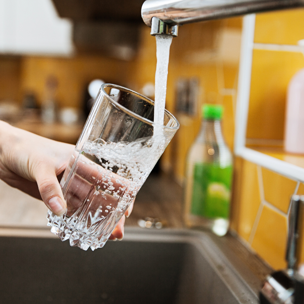 glass of water filled by a tap