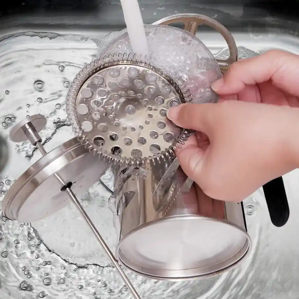cleaning a french press under tap water