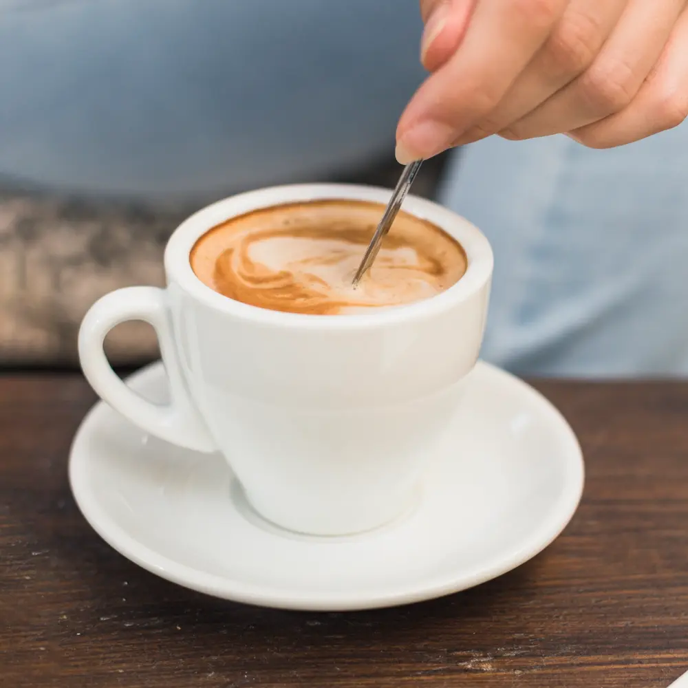 stirring the crema on a colada coffee