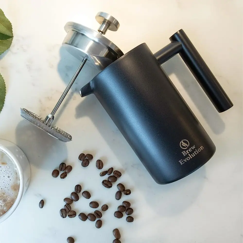 a matte press laying on its side with beans