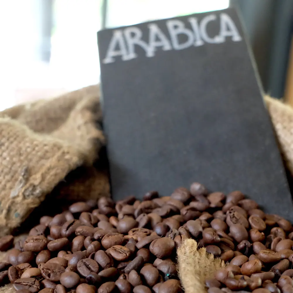 arabica coffee beans in a sac with a sign