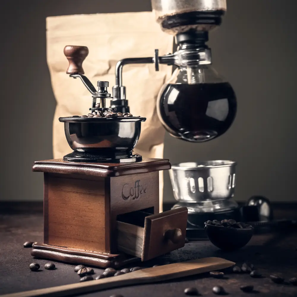 manual burr grinder with a siphon coffee maker