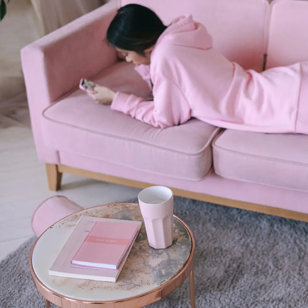 pink couch with pink sweater and pink books