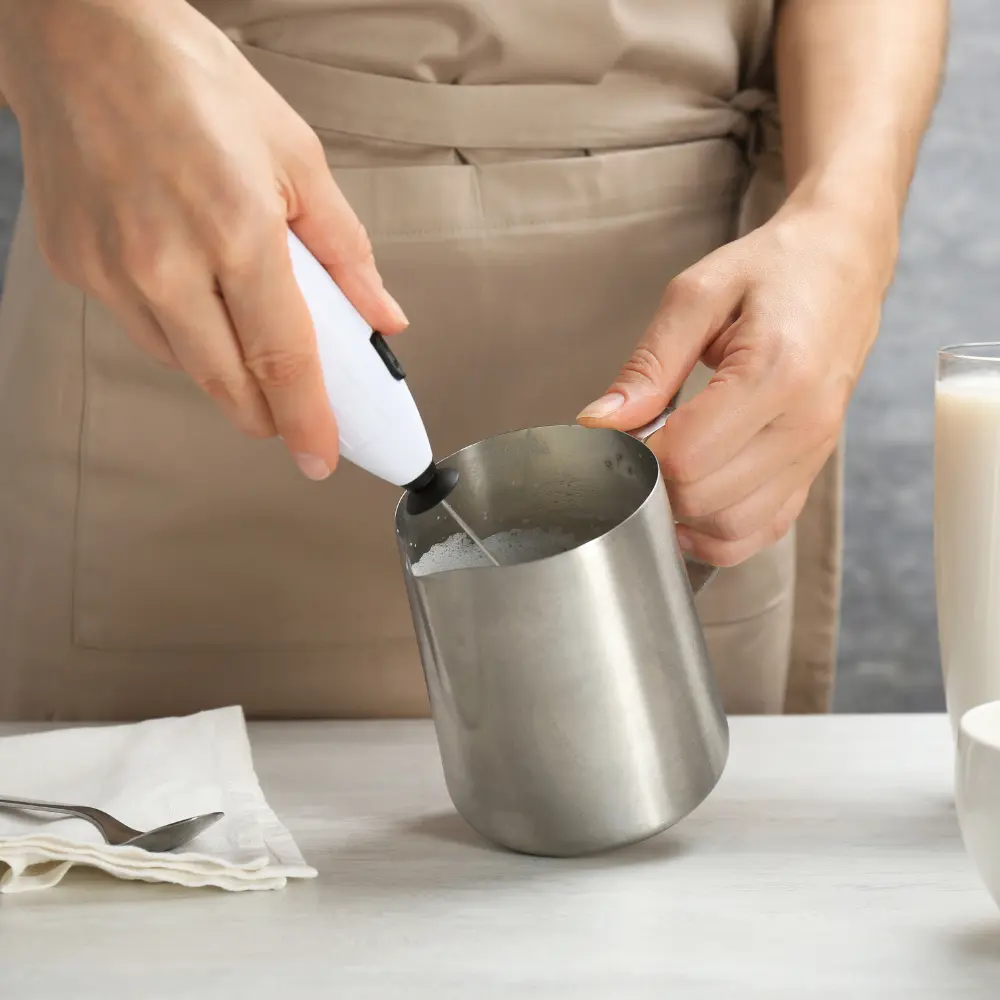 barista frothing milk